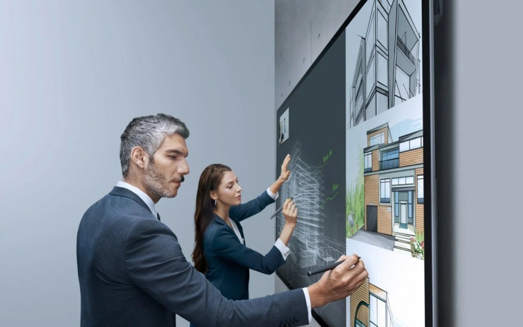 People interacting with a display powered by ultra-fine touch technology