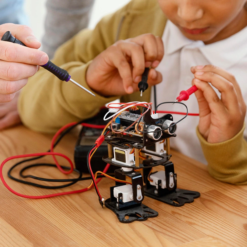 Student making a robot with robotics solution for schools